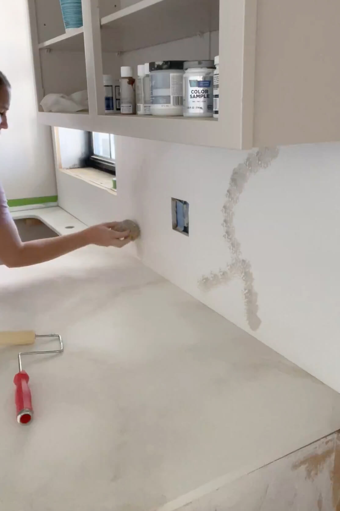 Painting a countertop for a faux marble finish. 